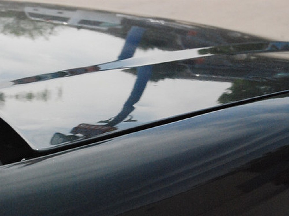 Reflection held flat across a finished panel